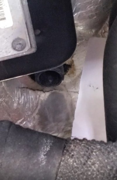 weep hole with paper next to it.jpg