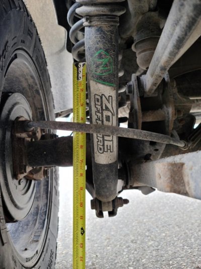 Passenger rear shock to show how off it is in a strait line.jpg