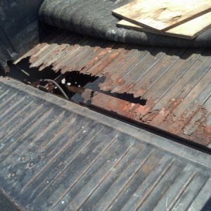 Massive hole in the bed. The plywood you see goes over the holes, which is then covered by the bedliner I got from a junkyard for like 8 bucks.