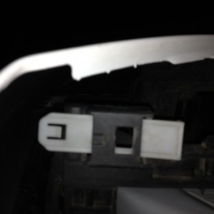 The clip that holds the headlights in after you remove the front two bolts. You can reach it from the tire well through a hole. Push up to release, an