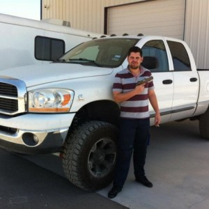 Pic taken in 2012.  A buddy of mine in front of the truck, cigarette, pistol, and a smile.  This was shortly after the lift was put on the truck.