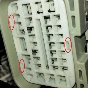 Front end side of the connector. Carefully pry up on the lock ring at the circled  tabs and remove.