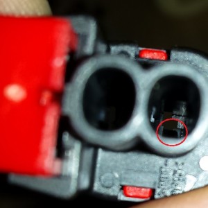 The back of the connector for the hood switch, notice the notch for aligning/locking the terminal.