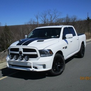 Ram 1500 with black wheels and KC lights.