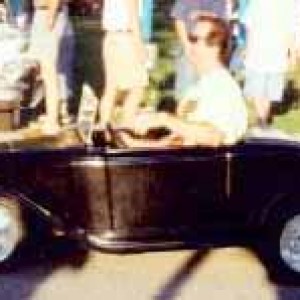 My dad in our mini 1932 Ford Roadster. This was at The Last Merc Duece Reunion in Davenport Iowa at Mississippi Valley Fairgrounds Davenport Iowa. Bel