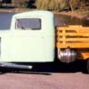 My dad's 1936 International C-1 in front of John Deere home world headquarters ( the Glass Palace ) in Moline Illinois.