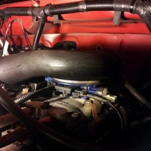 Throttle body recently cleaned and give a blue metallic paint job.