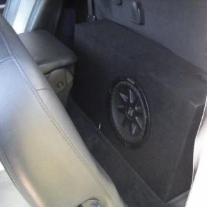Had a custom ported box made, put in a Kicker 10"