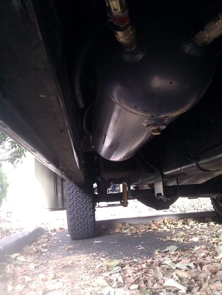 Air tank mounted under passenger seat. Does not hang below body or frame.