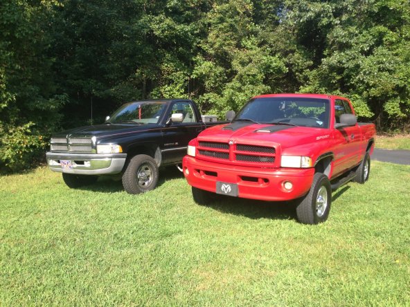 First day after I brought her home, sitting beside my cousin's truck. Mopar runs strong in our family lol.
