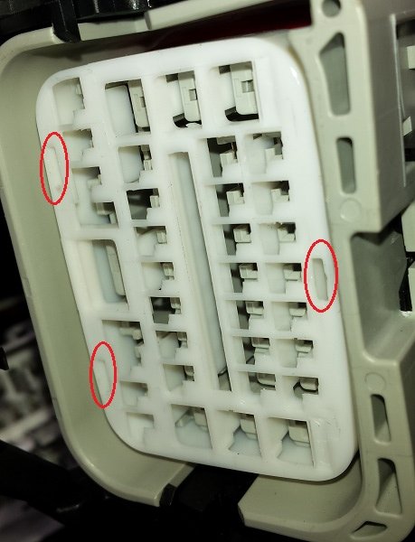 Front end side of the connector. Carefully pry up on the lock ring at the circled  tabs and remove.