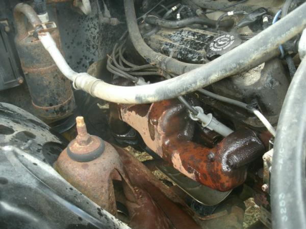 Replacing the cracked manifold. Truck sounded like **** or I would have left it go