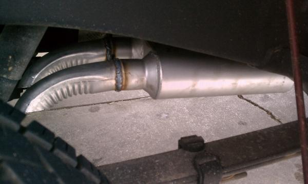 The pipes are angled out about 45° to the side of the truck